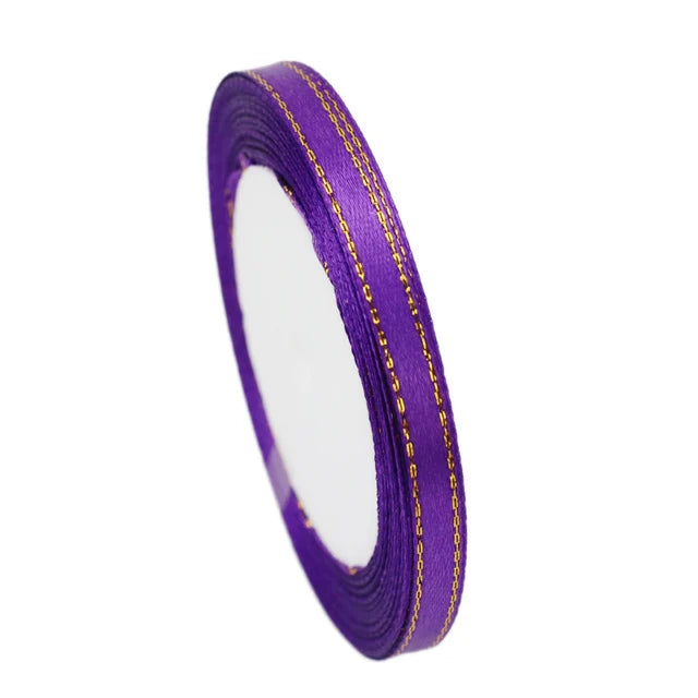 Roll of 6mm gold-edged satin ribbon in purple for gift wrapping and crafts