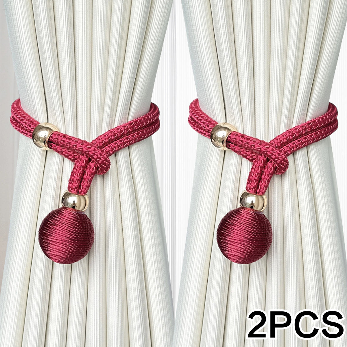 Two pink velvet ball tiebacks with gold accents shown against a white pleated curtain.