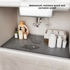 A silicone mat liner for an under sink cabinet, showing various bottles and a faucet setup.