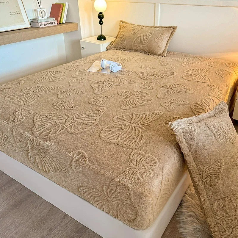 A beige jacquard weave fitted sheet bedding set on a white bed with matching pillows and a bedside lamp.