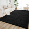 A black shaggy rug is placed on a light wood floor in a bright living room setting.