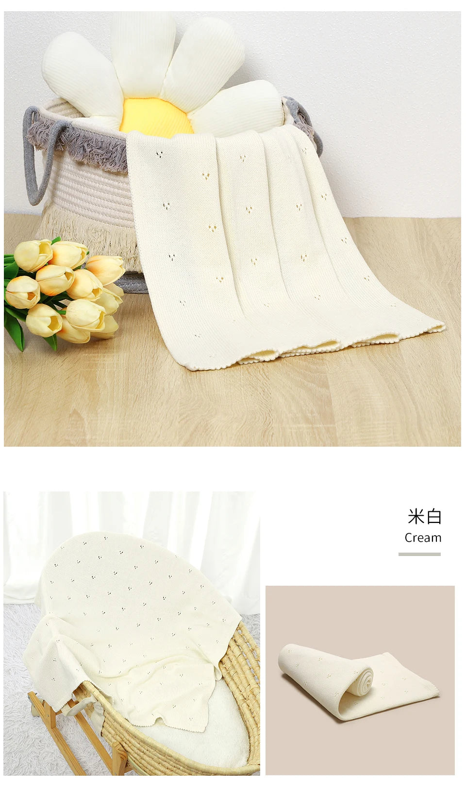 A cream-colored cotton knit baby blanket is displayed alongside a white flower and in a woven basket.
