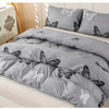 Gray duvet cover set featuring a butterfly print on a bed.
