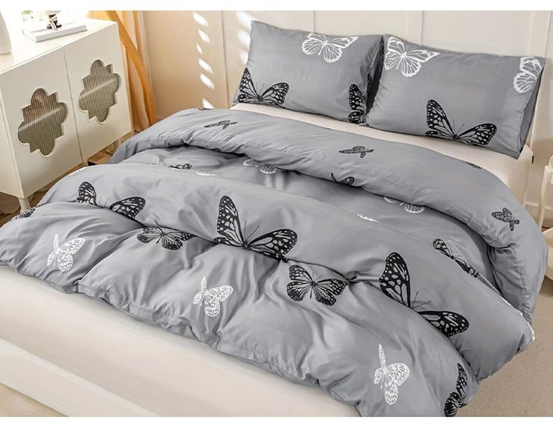Gray duvet cover set featuring a butterfly print on a bed.