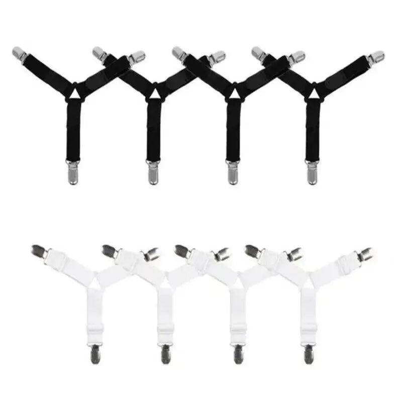 A set of four black adjustable bed sheet holder clips arranged in a row.