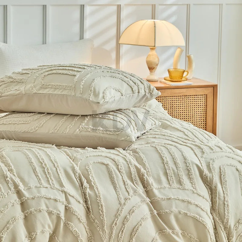 A beige embossed floral duvet cover set with matching pillowcases on a bed.
