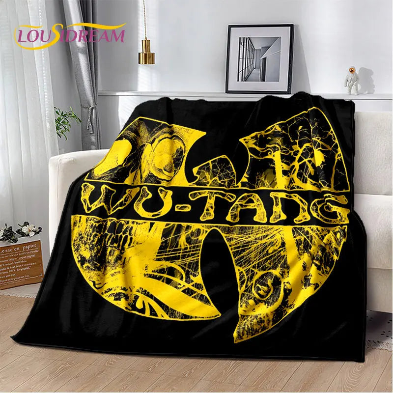 A black flannel throw blanket featuring a yellow graphic design with the text WU-TANG.