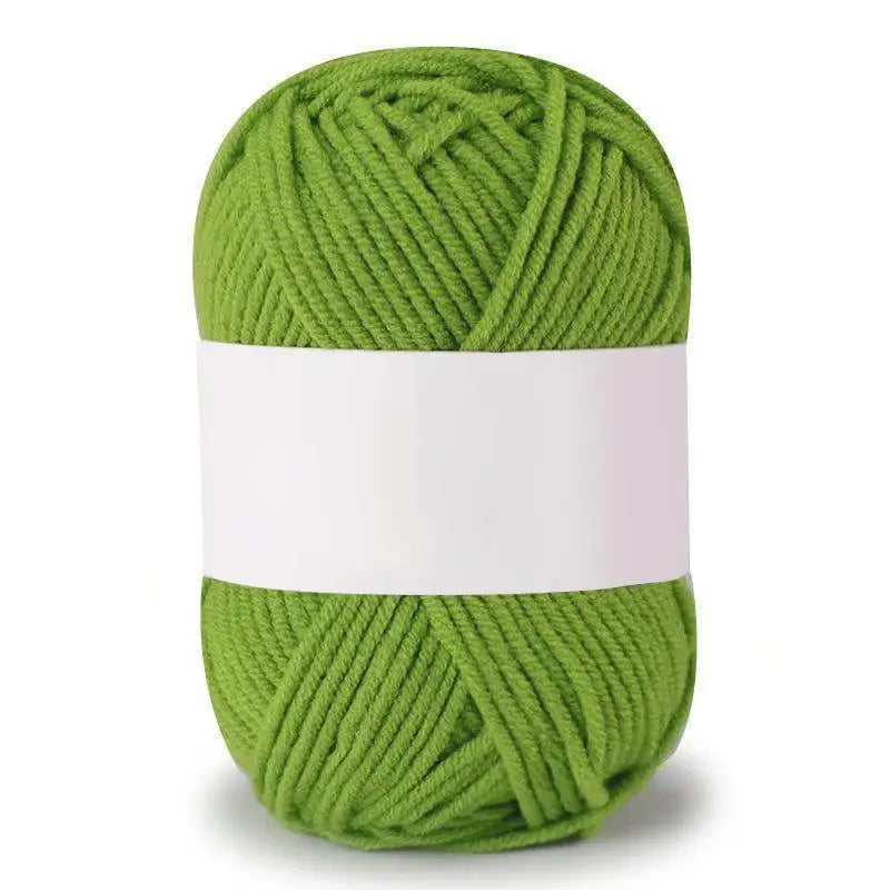 A ball of soft milk cotton knitting yarn in a light green color.