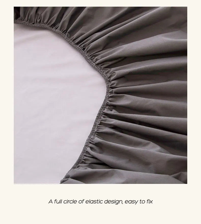Close-up of a gray elastic fitted bed sheet design showing the gathered fabric edge.
