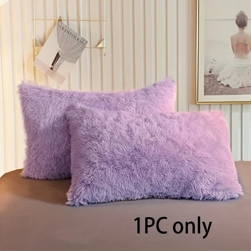 A single fluffy lavender faux fur pillow cover resting on a brown surface.