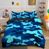 A blue and teal camouflage duvet cover set displayed on a bed with white nightstands and decorative items.