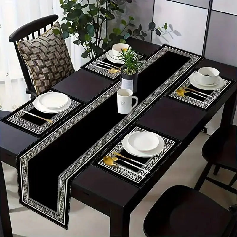 A dark wood dining table set with black placemats and white tableware, featuring geometric patterns.