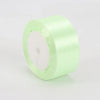 A roll of light green satin ribbon used for crafts and gift wrapping.