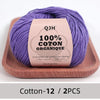 Purple QJH 100% organic cotton yarn skein displayed on a wooden tray.