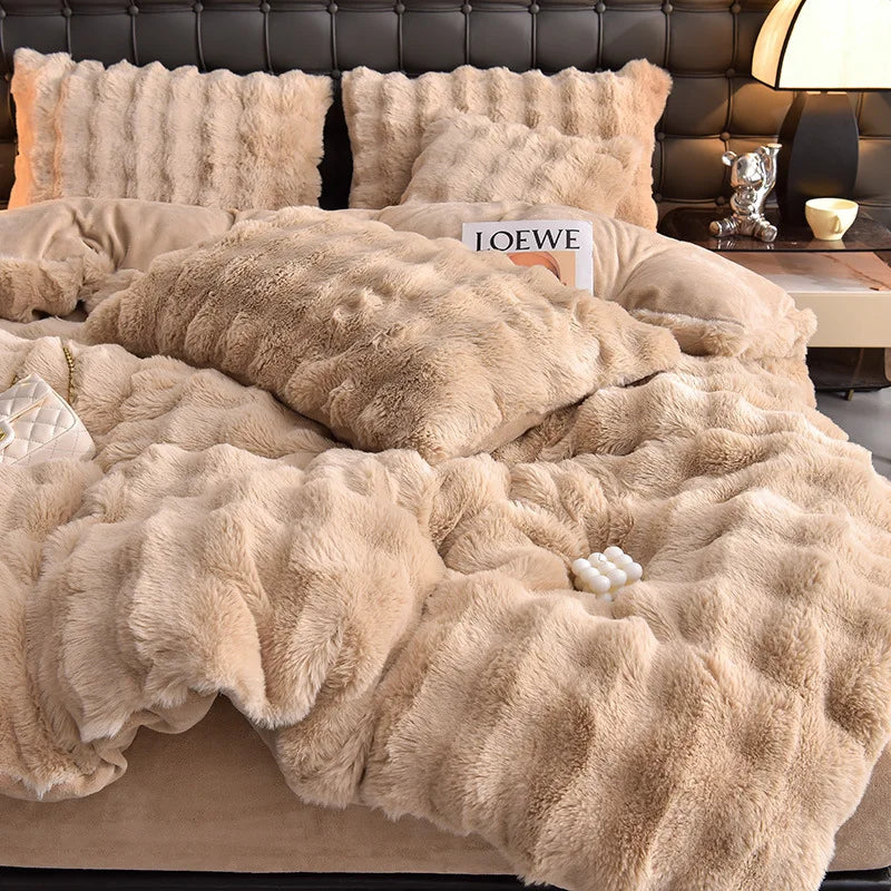 A beige plush rabbit hair bedding set featuring a fluffy duvet and pillows on a bed.
