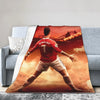 A football player in a red jersey is shown from the back, running across an orange and red sunset background.