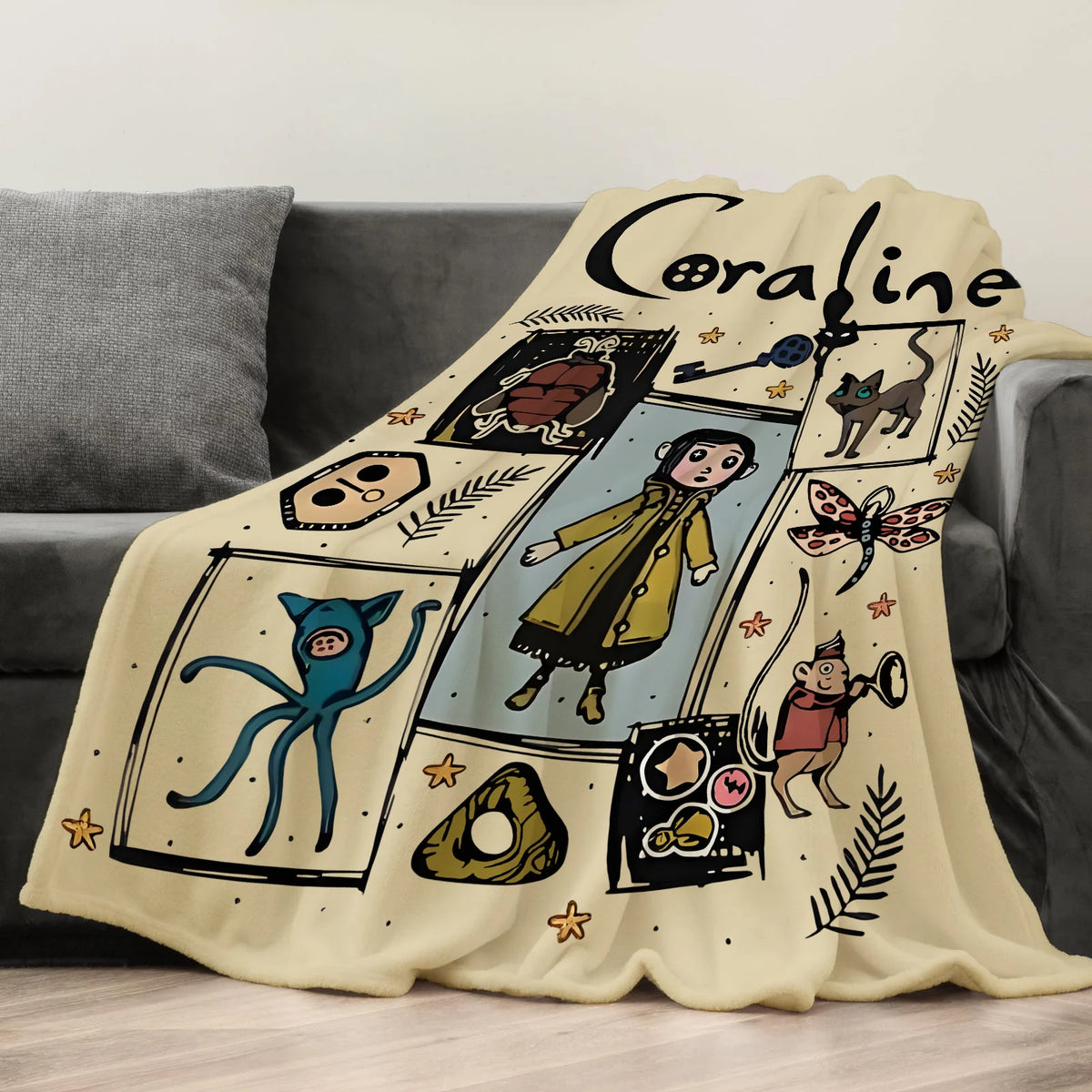 A cream colored flannel throw blanket featuring a graphic design of a cat and various illustrated elements.