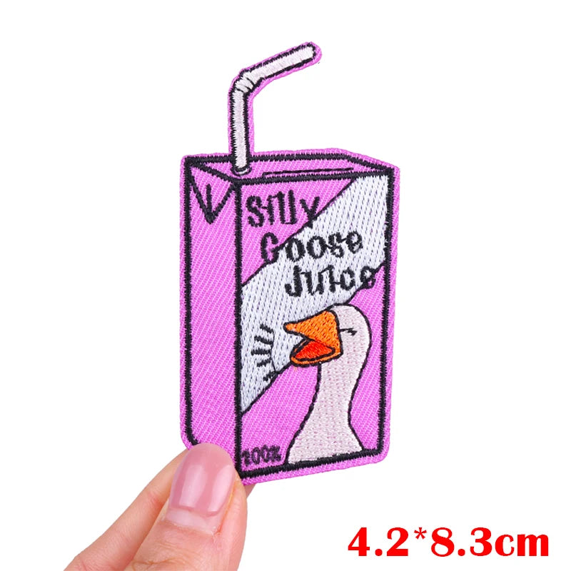 Pink embroidered patch featuring a goose face with a straw and text