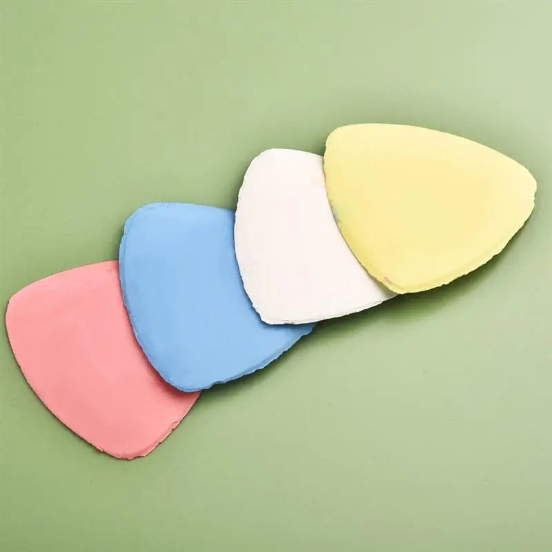 A set of five pastel colored erasable fabric chalk markers including pink, blue, white, and yellow on a green background.