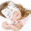 A baby is wearing a white animal cartoon sleep mask with pink accents while resting.