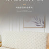 A close-up of a beige plush quilted headboard cover displayed in a minimalist bedroom setting.
