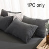 A set of dark gray and white pillows shown on a bed, with text indicating 1PC only.