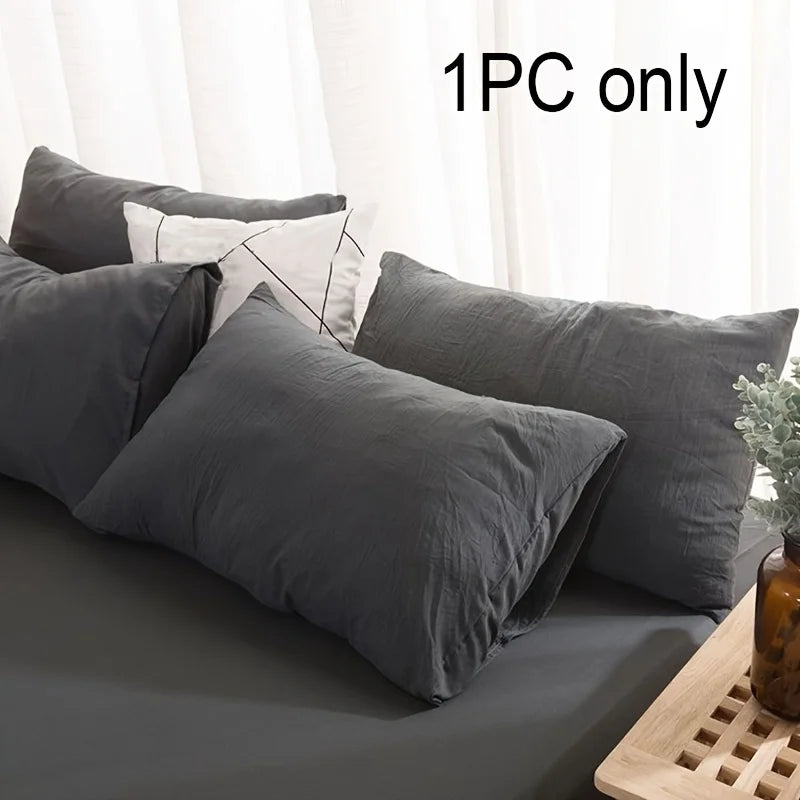 A set of dark gray and white pillows shown on a bed, with text indicating 1PC only.