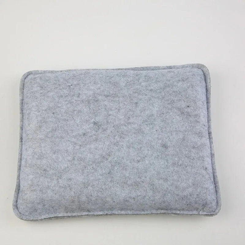 A square, gray needle felting mat pad with a stitched edge.