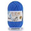 A ball of bright blue milk cotton yarn with a label in Chinese and English.