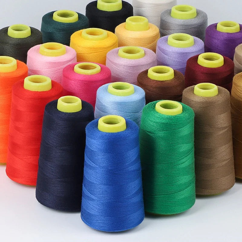 A collection of colorful premium sewing thread spools in various shades of green, yellow, pink, purple, and brown.