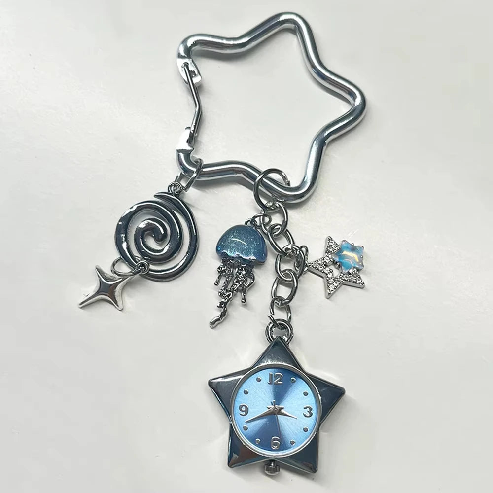 Silver star pocket watch keychain featuring a spiral charm and a blue-tinted clock face.