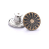 A round, dark bronze metal button with a floral pattern and a silver threaded post.