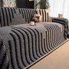 A dark gray bohemian striped sofa cover featuring vertical lines and a textured fabric.