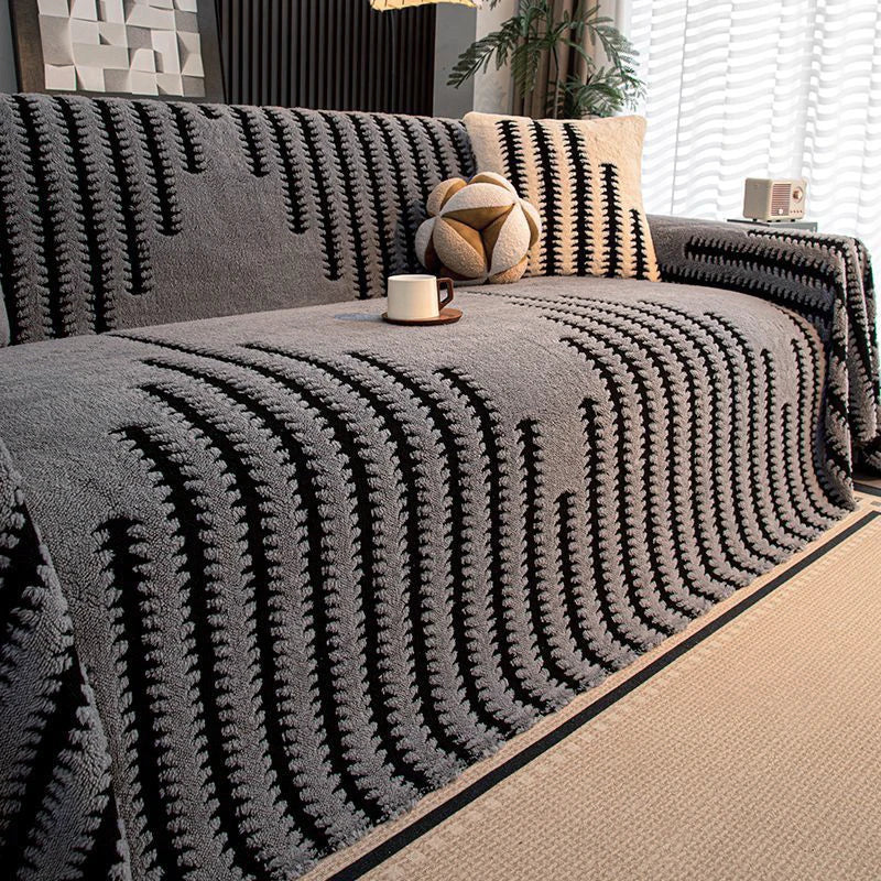 A dark gray bohemian striped sofa cover featuring vertical lines and a textured fabric.