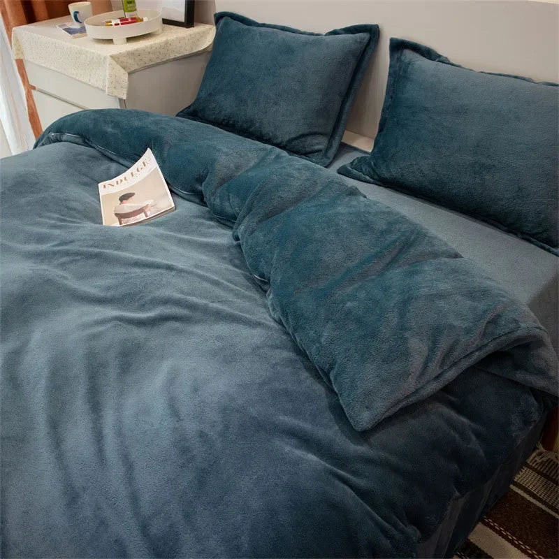 A dark teal luxurious flannel duvet cover set with matching pillows on a bed.