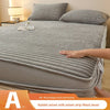A rabbit velvet milk velvet strip fitted sheet is shown on a bed, with a hand touching the fabric.