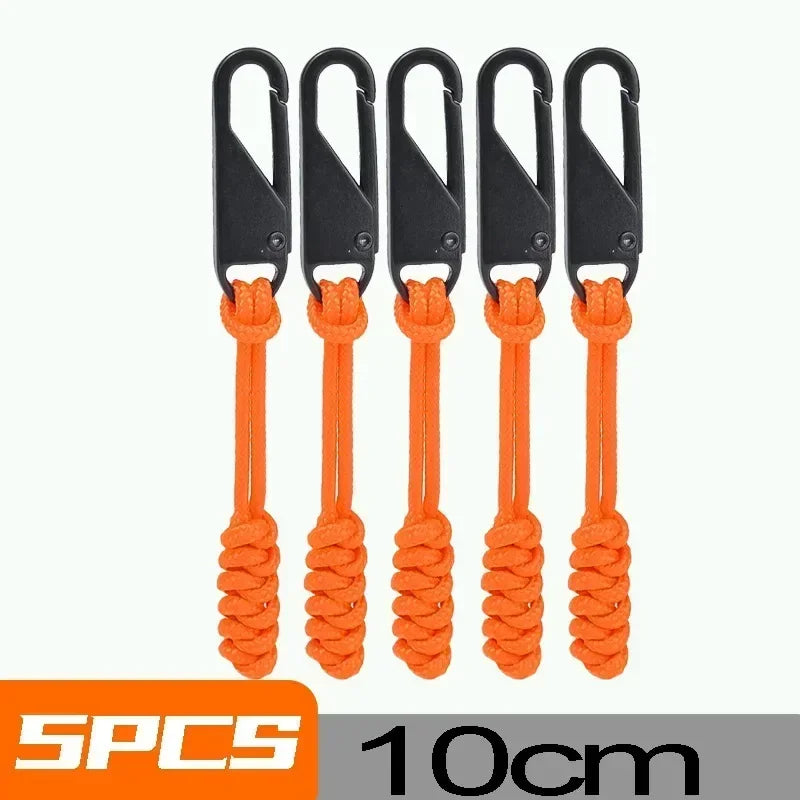 Five black detachable zipper pull sliders with orange cord for bags and clothing