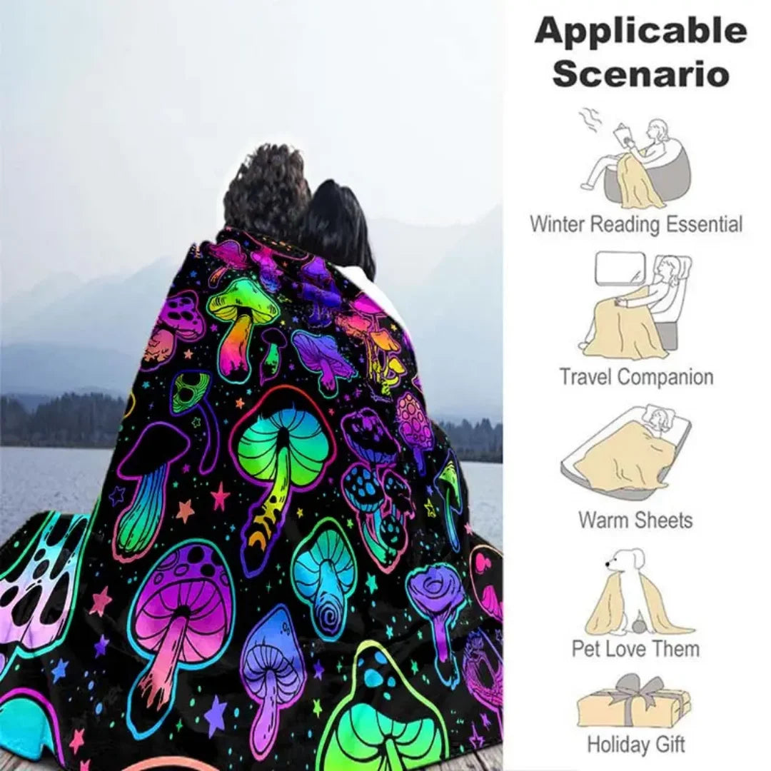A colorful mushroom flannel throw blanket displayed against a snowy mountain landscape.