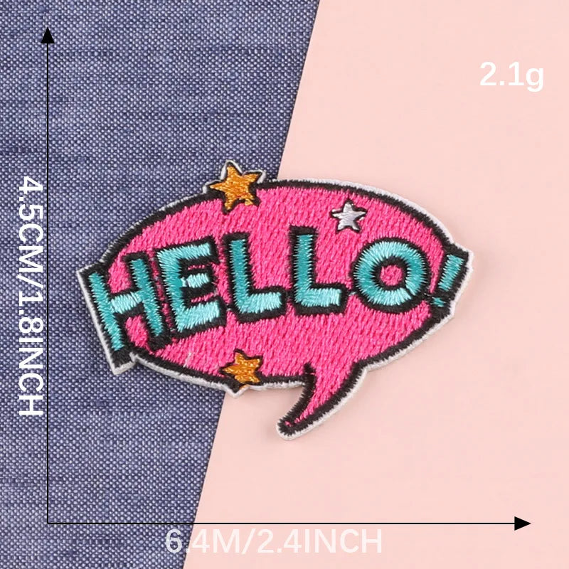 Pink embroidery patch with the word HELLO in teal stitching on a denim fabric background