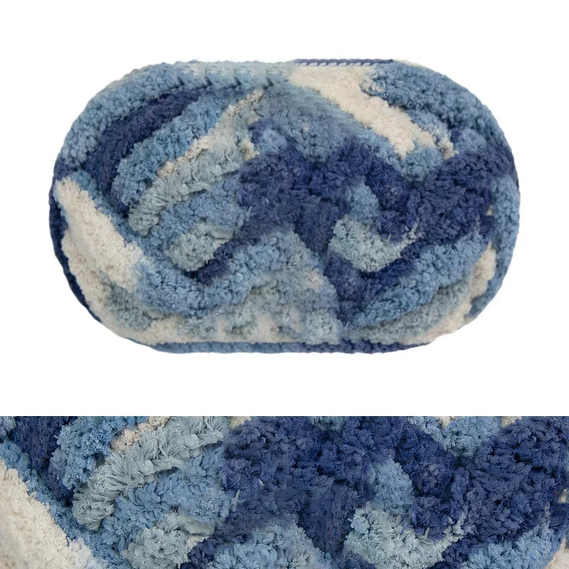 A round, hand-knitted wool finger line scarf in shades of blue and white.