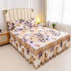 Luxury floral bed skirt in beige and purple tones protecting a mattress.