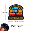 A black PVC patch featuring a cartoon animal face with text that reads It's fine I'm fine Everything is fine