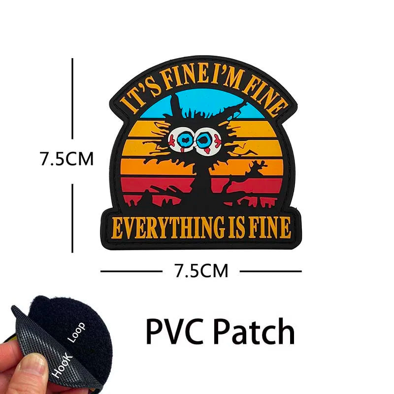 A black PVC patch featuring a cartoon animal face with text that reads It's fine I'm fine Everything is fine