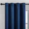 Solid blue blackout window curtain hanging from a black rod.