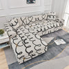 L-shaped sofa protector covers featuring a white and black wavy pattern on a gray fabric.