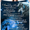 A dark blue blanket featuring a silhouette of a wolf and text encouraging strength and confidence for a son