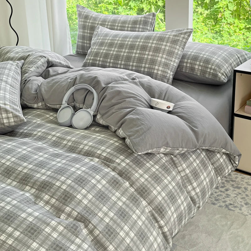 A gray and white checkered duvet cover set with matching pillows on a bed.