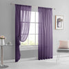 Purple sheer curtain hanging in a window frame in a modern living room setting.