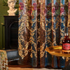 Neoclassical sheer curtains in blue and gold floral embroidery hanging next to a classical bust.