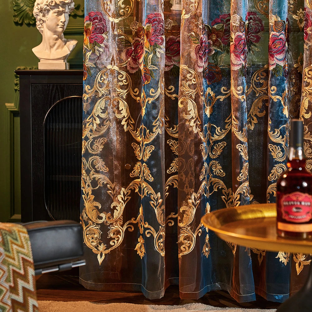 Neoclassical sheer curtains in blue and gold floral embroidery hanging next to a classical bust.